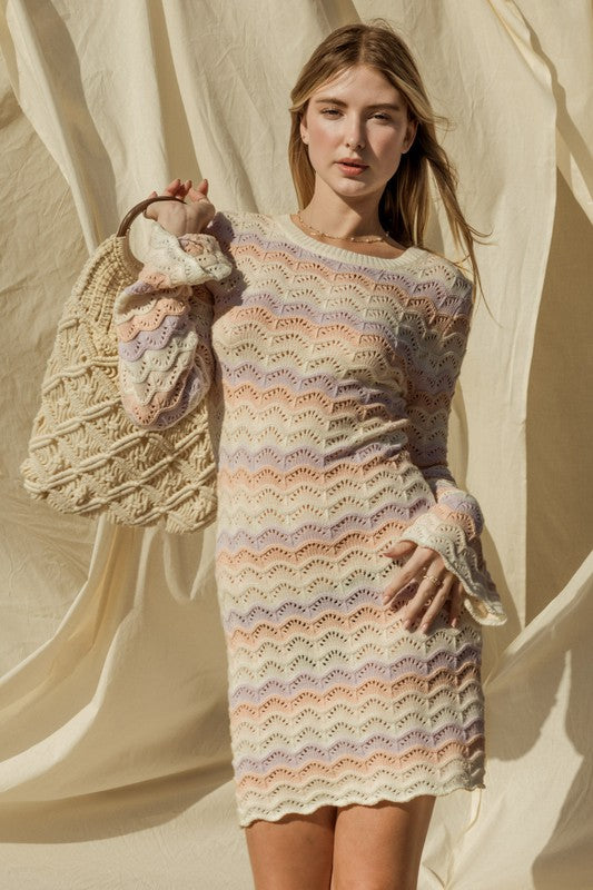 women wearing long sleeve ivory multi color sweater dress with bell sleeves